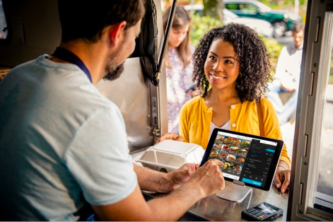 Worker accepting payment from customer for food 