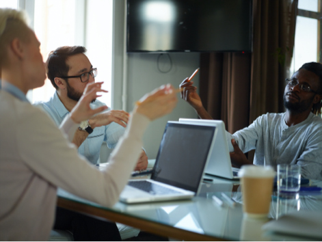 Three people having discussion at table