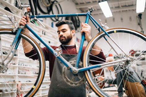 Worker lifting a bicycle in the air  
