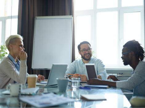 Three people working at a table 