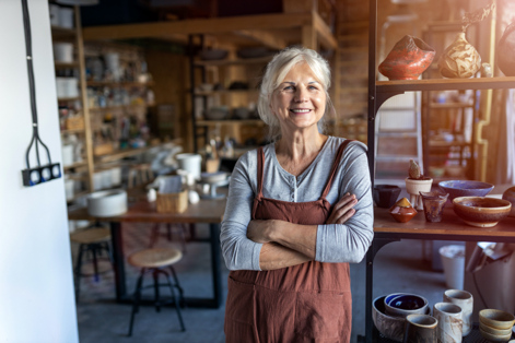 Worker standing in pottery store 