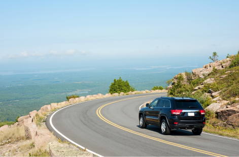 SUV driving along a scenic highway