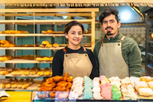 Small business owners at a bakery waiting for customers to arrive.