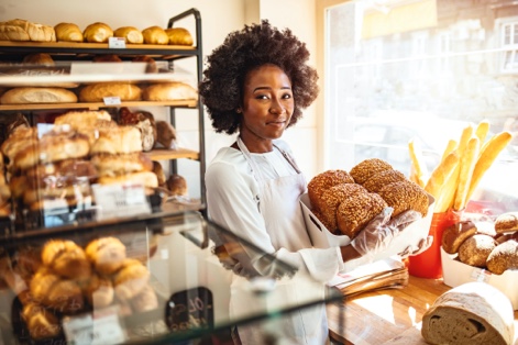 Worker holding basket of bread 